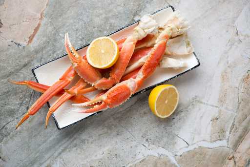 Plate with boiled snow crab and lemon